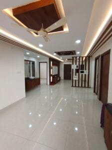 Completed home interior corridor with wooden false ceiling and cove lighting by SB Interior Solutions Hyderabad