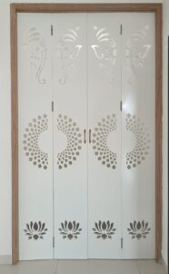 modern white pooja unit with a clean geometric jali back panel designed by SB Interior Solutions