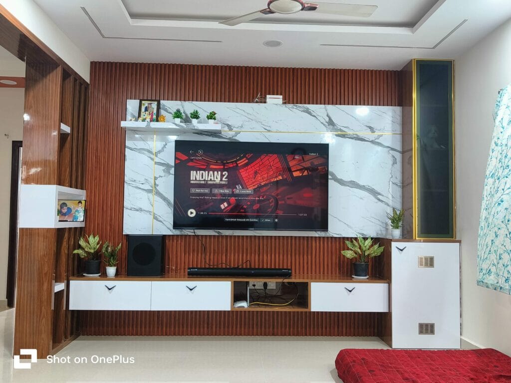 Completed bedroom interior with bed and red bedsheet by SB Interior Solutions Hyderabad